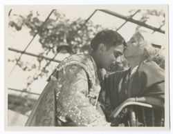 Item 0090. Same setting and subjects as Items 88-89 above. Woman kissing Liceaga on forehead.