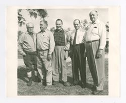 Roy Howard stands with others