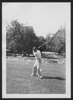 Hoagy Carmichael swinging a golf club.
