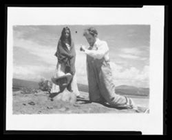Item 0390. Eisenstein kneeling, left. "Sebastian" buried to his chest in the sand -"Maria" (Isabel Villasenor) standing behind him.