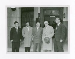 Roy Howard and others outside of a building