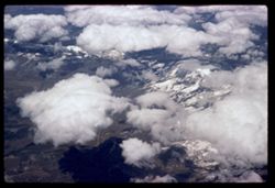 High Rockies below high clouds Air France 707 jet flight - L.A. to Paris