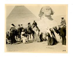 Group of people on camels in front of the Great Sphinx of Giza