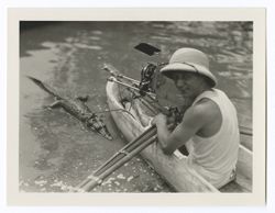 Item 0514. Various shots of Tissé , in canoe, with small alligator alongside. 8.6 x 11.2 cm.
