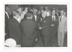 Group of men shaking hands at an event