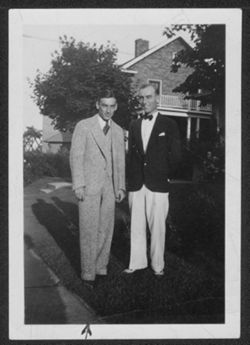 Hoagy Carmichael and an unidentified man outside of a house.