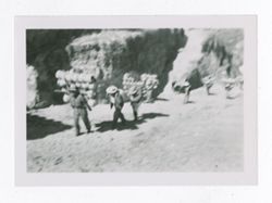 Blurry photo of men carrying goods