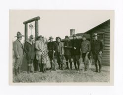 Men standing outside of cabins