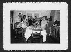Family photo at dinner table, early 1940s.