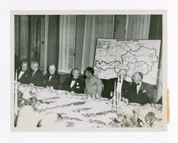 Roy Howard and other men at a meeting