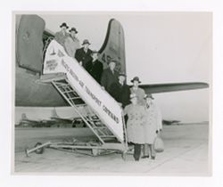 Roy Howard and others in front of airplane