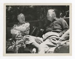 Two men sitting together at Bohemian Grove
