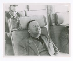 Jack R. Howard asleep on a plane