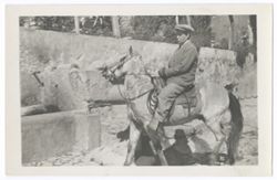 Item 0397. Eisenstein in business suit on horseback in courtyard of Hacienda. Trying to pull horse away from drinking fountain.