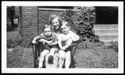 Georgia Carmichael seated in wicker chair holding nephews Randy and Hoagy Bix Carmichael.