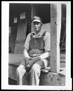 Unidentified male with pipe and coveralls
