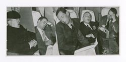 Roy Howard and others asleep on a plane