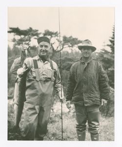 Frank Morrison and another man pose with fish