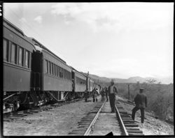 Train stopping, soldiers in distance