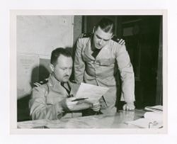 Jack Howard and another man looking at a document