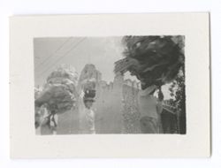 Item 0943. - 0955a. Various shots of religious procession of men carrying tall barrel-shaped objects. Church in background.