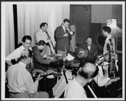 Nine musicians performing in a studio, including Buddy Cole at the piano.
