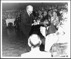 Hoagy Carmichael shaking hands with George Murday at an Indiana University Alumni Association event honoring Carmichael, Hollywood.