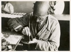 Man painting chinaware