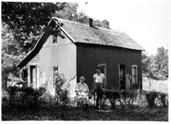 Ethel M. Moore and her son Charles in front of home on spur of Salt Creek, Brown County