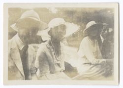 Item 0587. Two men and two women dressed in good clothes. Photo, faded and scratched, none can be identified.